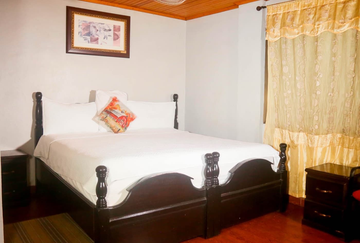 A comfortable single room with soft curtains at JC Guest House