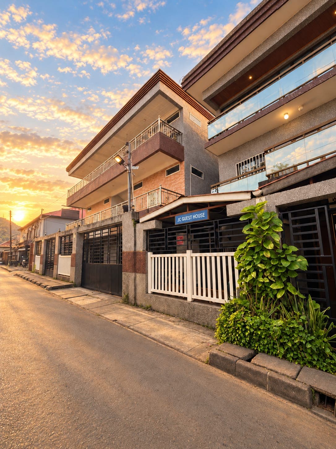 JC Guest House seen from Bailey Street at sunset with its sign above the gate